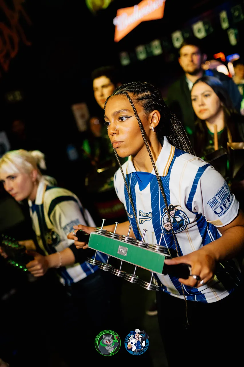 Ritmista da bateria da atlética tocando chocalho em festa